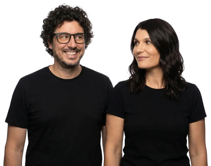 Dave and Emily, the hosts of Different Is Normal, smiling at each other.